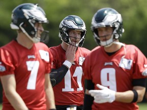 FILE - In this Thursday, June 7, 2018, file photo, Philadelphia Eagles quaterbacks Carson Wentz (11), Nick Foles (9), and Nate Sudfeld (7) walk to the next drill during practice at the NFL football team's training facility in Philadelphia. Wentz was having an MVP season before a torn ACL forced him to the sideline where he watched Nick Foles lead the Philadelphia Eagles to their first Super Bowl victory. His friendship with Super Bowl MVP Nick Foles appears without the strain seen in other famed NFL tandems.
