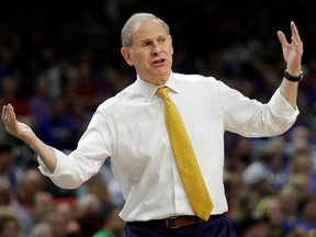 FILE - In this March 31, 2018, file photo, Michigan head coach John Beilein reacts to a call during the first half against Loyola-Chicago in the semifinals of the Final Four NCAA college basketball tournament, in San Antonio. After briefly emerging as a candidate for the Detroit Pistons' job, John Beilein is back at Michigan amid high expectations for next season.