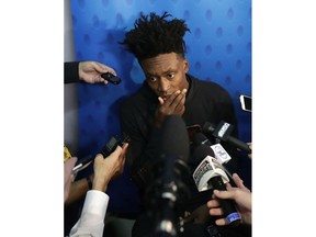 FILE - In this May 17, 2018, file photo, Collin Sexton, from Alabama, is interviewed at the NBA draft basketball combine, in Chicago. Most of the furniture was taken out of several rooms on the 15th and 16th floor of the hotel in downtown Chicago. There's a couple tables, a few chairs, and when the doors open to those suites draft hopefuls can make or break their futures in 20 minutes. This is where the interviews happen for the draft, where teams meet players and ask them about everything from their family histories to their thoughts on highway safety before investing millions of dollars.