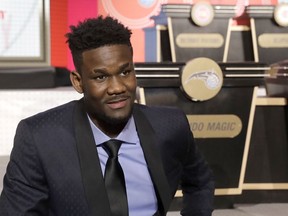 FILE - In this May 15, 2018, file photo, DeAndre Ayton sits on the stage before the NBA basketball draft lottery in Chicago. Ayton could be the Phoenix Suns choice with the no. 1 pick in this month's NBA Draft.