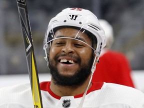 FILE - In this May 29, 2018, file photo, Washington Capitals right wing Devante Smith-Pelly laughs during practice in Las Vegas.  The Capitals have re-signed playoff hero Devante Smith-Pelly to a $1 million, 1-year contract. General manager Brian MacLellan announced the deal Thursday, June 28, 2018, less than 72 hours after not tendering a qualifying offer to the restricted free agent forward.