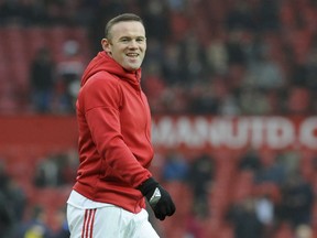 FILE - In this Jan. 7, 2017, file photo, Manchester United's Wayne Rooney warms up before a match against Reading in Manchester, England. English soccer star Wayne Rooney has signed with Major League Soccer's D.C. United. Rooney, 32, is the all-time leading scorer for England's national team and Manchester United in the Premier League. D.C. United announced the long-reported signing Thursday, June 28, 2018, hours after Rooney posted to Twitter a photo of himself on a plane with an emoji of the American flag.