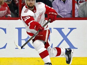 FILE - In this Feb. 2, 2018, file photo, Detroit Red Wings' Mike Green (25) clears the puck against the Carolina Hurricanes during the first period of an NHL hockey game, Friday,, in Raleigh, N.C. A person with direct knowledge of the move says the Red Wings have agreed to terms with Green on a $10.75 million, two-year contract. The person spoke to The Associated Press on condition of anonymity on Saturday, June 30, 2018, because the deal had not been announced. The 32-year-old will count $5.375 million against the salary cap over the next two seasons.