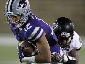 FILE - In this Sept. 24, 2016, file photo, Kansas State wide receiver Corey Sutton (12) is tackled by Missouri State cornerback Matt Rush during the first half of an NCAA college football game in Manhattan, Kan. College athletes will no longer need permission from their coach or school to transfer and receive financial aid from another school. The NCAA Division I Council approved the change Wednesday, June 13, 2018. It takes effect Oct. 15. Standoffs between athletes and coaches over transfers have often led to embarrassing results for schools standing in the way of player who wishes to leave. Last spring at Kansas State, reserve receiver Corey Sutton said he was blocked him from transferring to 35 schools by coach Bill Snyder before the school finally relented after public pressure.