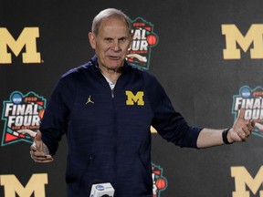 FILE - In this March 29, 2018, file photo, Michigan head coach John Beilein answers questions after a practice session for the Final Four NCAA college basketball tournament, in San Antonio. Beilein is staying at Michigan. He announced on Twitter on Wednesday, June 6, 2018, that he's excited about coaching the Wolverines next season and in the years to come. The 65-year-old Beilein has coached at Michigan for 11 seasons. He has led the Wolverines to two Final Fours, losing in the national title game this year and in 2013. Beilein has won a pair of Big Ten championships and two Big Ten Tournament titles. A person with knowledge of the situation told The Associated Press earlier this month Beilein interviewed with the Detroit Pistons about their coaching vacancy.