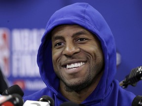 FILE - In this May 30, 2018, file photo, Golden State Warriors' Andre Iguodala smiles as he answers questions after an NBA basketball practice, in Oakland. The Warriors expect Iguodala to play in Game 3 of the NBA Finals, Wednesday night, June 6, 2018. Iguodala has been dealing with a bone bruise around his left knee. He has not played since Game 3 of the Western Conference finals against Houston.