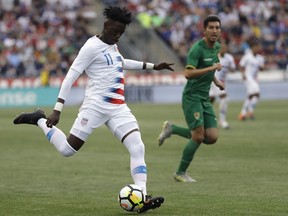FILE - In this May 28, 2018, file photo, United States' Tim Weah moves the ball during an international friendly soccer match against Bolivia, in Chester, Pa. Weah is part of a young American roster brought in following the end of the Americans' streak of seven straight World Cup appearances.