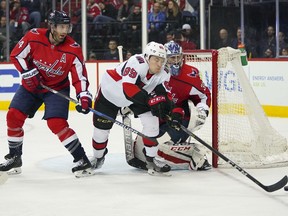 FILE - In this Feb. 27, 2018, file photo, Ottawa Senators left wing Max McCormick (89) misses a pass as he tries to score on Washington Capitals goaltender Philipp Grubauer (31) and defenseman Brooks Orpik (44) during the third period of an NHL hockey game in Washington. The Capitals have traded Orpik and Grubauer to the Colorado Avalanche for the 48th pick in the NHL draft. The teams announced the draft before the start of the draft Friday night,  June 22. The trade clears salary-cap space for Washington, which is attempting to re-sign pending free agent defenseman John Carlson.