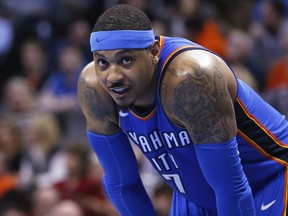 FILE - In this Feb. 13, 2018, file photo,  Oklahoma City Thunder forward Carmelo Anthony pauses during the team''s NBA basketball game against the Cleveland Cavaliers in Oklahoma City. Anthony plans to opt in and take the $28 million he is due next season. The New York Times first reported the 34-year-old Anthony's decision to bypass the chance to become a free agent. A person with knowledge of details confirmed Anthony's choice to The Associated Press on Friday night, June 22. The person spoke on the condition of anonymity because he was not authorized to discuss the situation publicly.