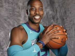 FILE - In this Sept. 25, 2017, file photo, Charlotte Hornets' Dwight Howard poses for a photo during the NBA basketball team's media day in Charlotte, N.C. A person familiar with the situation says the Charlotte Hornets have agreed to trade eight-time All-Star center Dwight Howard to the Brooklyn Nets for center Timofey Mozgov and two future second-round draft picks. The person spoke to The Associated Press on condition of anonymity Wednesday, June 20, 2018, because the teams have not announced the trade and the league has not yet approved it.