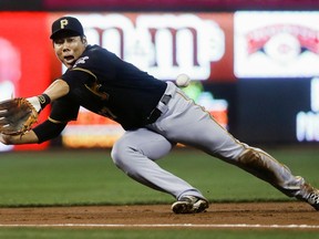 FILE - In this Friday, Sept. 16, 2016 file photo, Pittsburgh Pirates third baseman Jung Ho Kang misses a double hit by Cincinnati Reds' Adam Duvall in the first inning of a baseball game in Cincinnati. Pittsburgh Pirates infielder Jung Ho Kang said he has been sober since his third DUI arrest in December 2016 and is focused on getting into baseball shape and returning to the Pirates.