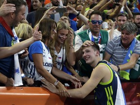 FILE - In this Sept. 14, 2017, file photo, Slovenia's Luka Doncic celebrates with the supporters at the end of their Eurobasket European Basketball Championship semifinal match against Spain, in Istanbul. Doncic is a possible pick in Thursday's NBA Draft.