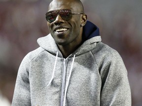 FILE - In this Nov. 19, 2016, file photo, former NFL wide receiver and Chattanooga alum Terrell Owens walks the sidelines during the second half of an NCAA college football game between Alabama and Chattanooga, in Tuscaloosa, Ala. Terrell Owens says he will not attend the induction ceremony for the Pro Football Hall of Fame in August, an unprecedented decision by an enshrinee. Owens was voted into the hall in February. In a statement released Thursday, June 7, 2018, by his publicist, Owens says: "While I am incredibly appreciative of this opportunity, I have made the decision to publicly decline my invitation to attend the induction ceremony in Canton."