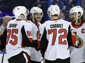 FILE - In this March 13, 2018, file photo, Ottawa Senators left wing Mike Hoffman, second from left, celebrates with defenseman Erik Karlsson, of Sweden, right, defenseman Thomas Chabot, second from right, and center Matt Duchene, left, after scoring against the Tampa Bay Lightning during the third period of an NHL hockey game in Tampa, Fla. The Florida Panthers have acquired Mike Hoffman from San Jose hours after the Sharks got the scoring winger from the Ottawa Senators. Florida sent 2018 fourth- and fifth-round picks and a 2019 second-round pick to San Jose for Hoffman and a 2018 seventh-round pick. General manager Dale Tallon announced the trade Tuesday, June 19, 2018, not long after Ottawa moved him to San Jose.