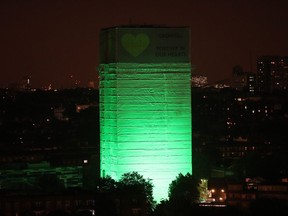 Grenfell Tower in west London is illuminated in green to mark a year since the moment the devastating fire took hold, claiming 72 lives, Thursday June 14, 2018. Thursday marks 12 months since a small kitchen fire in the high-rise turned into the most deadly domestic blaze since the Second World War.