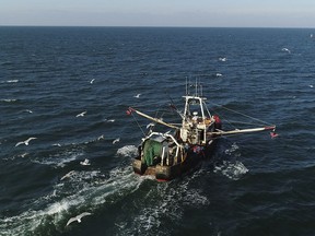 A fishing trawler makes its way to open water from Montauk, N.Y. for a day trip to fish off the coast Long Island on Tuesday, Dec. 19, 2017.