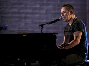 FILE - In this June 10, 2018, file photo, Bruce Springsteen performs at the 72nd annual Tony Awards at Radio City Music Hall in New York. Springsteen helped rock a refurbished 1960s bowling alley-turned music venue a stone's throw from the Asbury Park boardwalk. Actor Hugh Jackman was in the house at the Asbury Lanes Monday, June 18, as Springsteen jammed for about 30 minutes with Tangiers Blues Band.