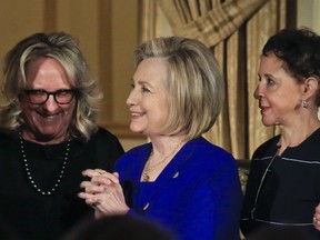 Former U.S. Secretary of State Hillary Clinton, center, stands with Sheila Johnson, right, founder and CEO of Salamander Hotels and Resorts and BET co-founder, and Deirdre Quinn, left, CEO and co-founder of Lafayette 148 New York, after they received the 2018 Elly Award, Monday, June 18, 2018, in New York.