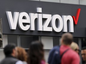 FILE- In this Tuesday, May 2, 2017, file photo, Verizon corporate signage is captured on a store in Manhattan's Midtown area, in New York. Verizon is pledging to stop selling data to outsiders through middlemen that can pinpoint the location of mobile phones, the Associated Press has learned.