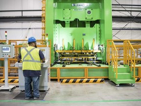 FILE- In this March 16, 2018, file photo a worker operates a press at the Samsung washing machine facility in Newberry, S.C. On Friday, June 1, the Institute for Supply Management, a trade group of purchasing managers, issues its index of manufacturing activity for May.