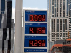 FILE- In this April 18, 2018, file photo, gas prices are displayed at a Mobil station in New York. President Donald Trump is declaring that oil prices are too high and blaming a coalition of countries that control a significant portion of the world's supply of crude petroleum. Trump tweeted on Wednesday: "Oil prices are too high, OPEC is at it again. Not good!"