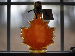 FILE- In this March 9, 2016, file photo, a bottle of maple syrup are displayed at the Merrifield Farm and Sugar Shack in Gorham, Maine. The U.S. Food and Drug Administration is reconsidering its plan to label pure maple syrup and honey as containing added sugars. Maple syrup producers had rallied against the plan, saying FDA's upcoming requirement to update nutrition labels to tell consumers that pure maple syrup and honey contain added sugars was misleading, illogical and confusing and could hurt their industries.