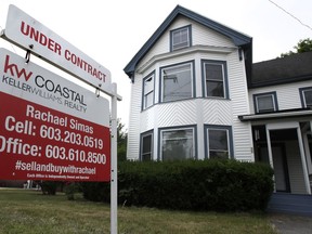 In this Wednesday, June 20, 2018, photo, an "Under Contract" sign is displayed in front of home for sale in Raymond, N.H. On Wednesday, June 27, the National Association of Realtors releases its May report on pending home sales.