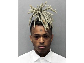 This undated mugshot released by the Miami- Dade Corrections & Rehabilitation Department shows rapper XXXTentacion. Authorities say troubled rapper-singer XXXTentacion has been fatally shot in Florida. The Broward Sheriff's Office says the 20-year-old rising star was pronounced dead Monday, June 18, 2018 at a Fort Lauderdale-area hospital. He was shot earlier outside a Deerfield Beach motorcycle dealership. (Miami- Dade Corrections & Rehabilitation Department via AP)