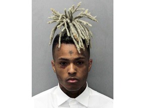 This undated mugshot released by the Miami- Dade Corrections & Rehabilitation Department shows rapper XXXTentacion. Following his death on June 18, 2018, XXXTentacion has topped the Billboard Hot 100 chart with "Sad!" and his two albums have landed in the Top 10. (Miami- Dade Corrections & Rehabilitation Department via AP)