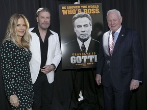 This image released by Starpix shows actors Kelly Preston, left, and John Travolta, stars of the upcoming film, "Gotti," posing with the movie poster and New York State Senator Marty Golden in the Brooklyn borough of New York on Tuesday, June 12, 2018.