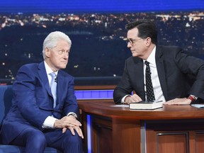 In this image released by CBS, former President Bill Clinton, left, appears with host Stephen Colbert while promoting his book "The President is Missing," on "The Late Show with Stephen Colbert," Tuesday, June 5, 2018 in New York.