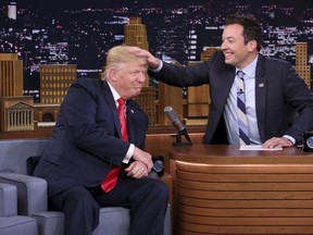 FILE - In this Sept. 15, 2016 image originally released by NBC, Republican presidential candidate Donald Trump appears with host Jimmy Fallon during a taping of "The Tonight Show Starring Jimmy Fallon," in New York.  Fallon is opening up about the personal anguish he felt following the backlash to his now-infamous hair mussing appearance with Donald Trump. Trump opponents criticized Fallon for a cringeworthy interview only weeks before the election where Fallon playfully stroked Trump's hair.