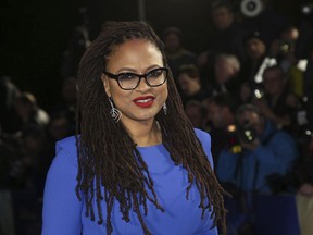 FILE - In this March 13, 2018 file photo, director Ava DuVernay appears at the premiere of "A Wrinkle In Time," in London.  DuVernay has checked off another milestone for black female directors. This week her film "A Wrinkle in Time" crossed the $100 million mark domestically, a first for a black woman.