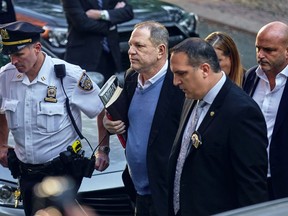 FILE - In this May 25, 2018, file photo, Harvey Weinstein arrives at the first precinct while turning himself to authorities following allegations of sexual misconduct in New York. Weinstein is scheduled to be arraigned in New York on rape and criminal sex act charges. The hearing on Tuesday, June 4, in NY's Manhattan borough comes after a grand jury indicted the former movie mogul on charges involving two women.