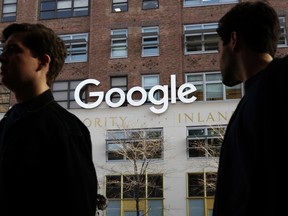 In this Dec. 4, 2017, photo, people walk by Google offices in New York. Google is blaming "vandalism" at Wikipedia for search results that incorrectly said the ideology of the California Republican Party included "Nazism." The results appeared in a Google information box screen-captured by Vice Media on Thursday, May 31, 2018. Google quickly removed the section on ideology.