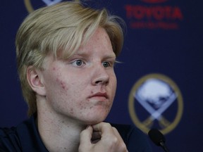 Defenseman Rasmus Dahlin, of Sweden, left, the Buffalo Sabres No. 1 pick at the NHL draft on Friday, poses with Sabres general manager Jason Botterill during an NHL hockey news conference, Monday, June 25, 2018, in Buffalo N.Y.