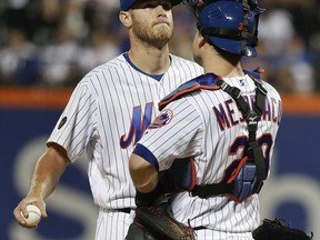 New York Mets starting pitcher Zack Wheeler, left, reacts as he waits with catcher Devin Mesoraco (29) to be relieved during the seventh inning of a baseball game against the Chicago Cubs, Friday, June 1, 2018, in New York.