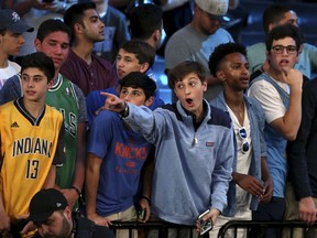 Basketball fans look for draft prospects before the NBA basketball draft in New York, Thursday, June 21, 2018.