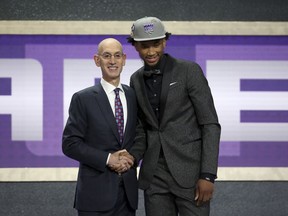 Duke's Marvin Bagley III, right, poses with NBA Commissioner Adam Silver after he was picked second overall by the Sacramento Kings during NBA basketball draft in New York, Thursday, June 21, 2018.