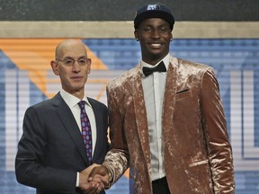 Michigan State's Jaren Jackson Jr. right, poses with NBA Commissioner Adam Silver after he was picked fourth overall by the Memphis Grizzlies during the NBA basketball draft in New York, Thursday, June 21, 2018.