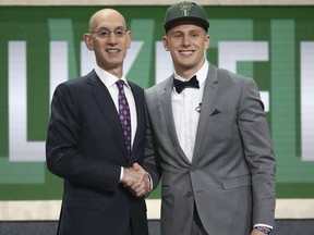 Villanova's Donte DiVincenzo, right, poses with NBA Commissioner Adam Silver after he was selected 17th overall by the Milwaukee Bucks during the NBA basketball draft in New York, Thursday, June 21, 2018.
