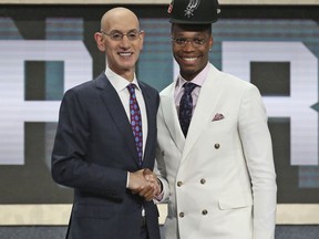 Miami's Lonnie Walker IV, right, poses with NBA Commissioner Adam Silver after he was picked 18th overall by the San Antonio Spurs during the NBA basketball draft in New York, Thursday, June 21, 2018.