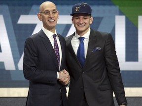 Duke's Grayson Allen, right, poses with NBA Commissioner Adam Silver after he was picked 21st overall by the Utah Jazz during the NBA basketball draft in New York, Thursday, June 21, 2018.