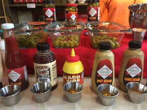 This June 4, 2018 photo shows Tabasco-infused olives and other food and dips in a free taste sample display on Avery Island in Louisiana, where Tabasco sauce is made. Tabasco was first made in 1868 and celebrates its 150th year this year. Visitors can see exhibits about the history of the famous pepper sauce, view the factory production, enjoy free tastings and samples, shop, dine and also tour a nature preserve called Jungle Gardens.