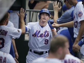 New York Mets' Brandon Nimmo celebrates with teammates after scoring on a double hit by Wilmer Flores during the third inning of a baseball game against the Los Angeles Dodgers at Citi Field, Sunday, June 24, 2018, in New York.