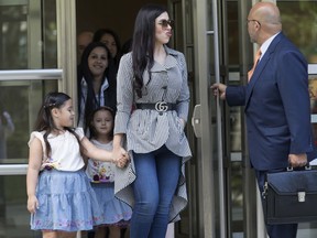 Emma Coronel, wife of Mexican drug lord Joaquin "El Chapo" Guzman leaves federal court in the Brooklyn borough of New York with her daughters, Tuesday, June 26, 2018. The upcoming trial of Guzman could get moved from Brooklyn to Manhattan.