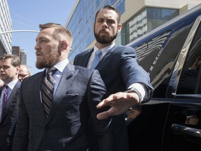 Mixed martial arts fighter Conor McGregor leaves a Brooklyn Supreme court, Thursday, June 14, 2018, in New York.  McGregor is in plea negotiations to resolve charges stemming from a backstage melee at a Brooklyn arena. The 29-year-old Irish fighter and co-defendant Cian Cowley remained free on bail after a brief court appearance on Thursday. They are due back in court July 26.