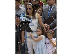 Sandra Chica, center, wife of Pablo Villavicencio, stands with their two daughters during a news conference outside federal immigration offices, Monday, June 18, 2018, in New York. Villavicencio was arrested June 1 while delivering pizza to Fort Hamilton in Brooklyn. He is being held on immigration law violations. Chica is fighting his deportation.