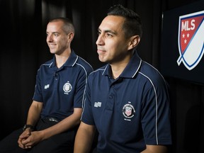 In this May 16, 2018 photo American soccer referees Mark Geiger, left, and Jair Marrufo are interviewed in New York. While the United States is missing from soccer's showcase for the first time since 1986, it is the only nation with two referees working the tournament. Geiger will become the second American to referee at two World Cups. The 43-year-old from Beachwood, New Jersey, worked Chile-Spain and Colombia-Greece during the group stage in Brazil four years ago, then became the first American to work a knockout stage match. Marrufo will be working his first World Cup after getting cut in 2010.