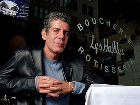 FILE - This Dec. 19, 2001 file photo shows Anthony Bourdain, the owner and chef of Les Halles restaurant, sitting at one of the tables in New York. On Friday, June 8, 2018, Bourdain was found dead in his hotel room in France, while working on his CNN series on culinary traditions around the world.